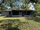 A large, screened-in back porch offers a relaxing outdoor living space in this charming home at 6489 Creation St, St Cloud, FL 34771