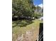 Expansive backyard with mature trees, a fence, and hot tub at 6489 Creation St, St Cloud, FL 34771