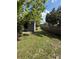 Backyard featuring a wooden fence, lush lawn, and a storage shed at 6489 Creation St, St Cloud, FL 34771