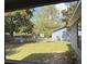 Spacious backyard featuring a lush lawn, mature trees, a fence, hot tub, and play equipment at 6489 Creation St, St Cloud, FL 34771