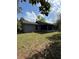 Exterior view of the home and backyard featuring a screened-in porch and lush lawn at 6489 Creation St, St Cloud, FL 34771