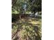 Large backyard with plenty of shade from mature trees and a wooden fence at 6489 Creation St, St Cloud, FL 34771
