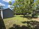 The backyard features mature trees, an open area, and a storage shed at 6489 Creation St, St Cloud, FL 34771