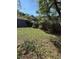 Backyard featuring a shed, wooden fence, and mature trees providing ample shade at 6489 Creation St, St Cloud, FL 34771