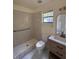 Well-lit bathroom with a walk-in shower, modern vanity, and toilet at 6489 Creation St, St Cloud, FL 34771