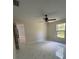 Bright bedroom features stylish flooring, a ceiling fan, and a window with natural light at 6489 Creation St, St Cloud, FL 34771
