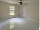 Spacious bedroom featuring stylish tile flooring, a ceiling fan, and a window with natural light at 6489 Creation St, St Cloud, FL 34771