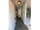 Entryway with carpeted floor leads to spacious living area with white marble tile and neutral-toned walls at 6489 Creation St, St Cloud, FL 34771