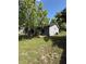 This home's exterior features gray siding, mature trees, and a well-manicured lawn at 6489 Creation St, St Cloud, FL 34771