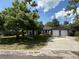 Charming single-story home with a two-car garage, gray siding, stone accents, and a well-maintained lawn at 6489 Creation St, St Cloud, FL 34771