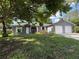 Charming single-story home with a two-car garage, gray siding, stone accents, and a well-maintained lawn at 6489 Creation St, St Cloud, FL 34771