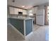 Stylish kitchen featuring a peninsula island, modern appliances, and marble tile transitioning to tile floors at 6489 Creation St, St Cloud, FL 34771