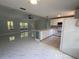 Open floor plan with an island bar, kitchen cabinets, and a large sliding door at 6489 Creation St, St Cloud, FL 34771