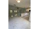 Open floor plan with an island bar, kitchen cabinets, and a large sliding door at 6489 Creation St, St Cloud, FL 34771