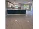 Bright open-concept kitchen with a peninsula island, modern appliances, and stunning marble floors at 6489 Creation St, St Cloud, FL 34771