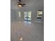 Spacious living room with large windows offering lots of natural light and elegant marble floors at 6489 Creation St, St Cloud, FL 34771