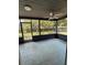 Inviting screened porch with a ceiling fan and views of the backyard at 6489 Creation St, St Cloud, FL 34771