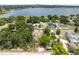 Aerial view of the home, showcasing the lush landscaping and proximity to the beautiful lake at 710 Carlton Ave, Lake Wales, FL 33853