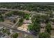 Aerial view of the property featuring its expansive lot, mature trees, and neighborhood context at 710 Carlton Ave, Lake Wales, FL 33853