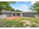 Backyard featuring grass, a concrete patio, and a privacy fence at 710 Carlton Ave, Lake Wales, FL 33853