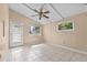 Bright bedroom with a ceiling fan, tiled floors, and natural light from windows at 710 Carlton Ave, Lake Wales, FL 33853