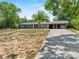 Charming single-story home featuring a spacious front yard and long concrete driveway at 710 Carlton Ave, Lake Wales, FL 33853