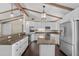 Bright kitchen with white cabinetry, granite countertops, stainless steel appliances, and an island at 710 Carlton Ave, Lake Wales, FL 33853