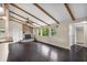 Inviting living room with dark hardwood floors, exposed beams, and a stone fireplace at 710 Carlton Ave, Lake Wales, FL 33853