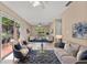Bright living room with tile floors and large sliding glass doors leading to the patio at 710 Carlton Ave, Lake Wales, FL 33853