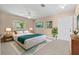 Main bedroom with ceiling fan, tile floors and a pair of windows with natural lighting at 710 Carlton Ave, Lake Wales, FL 33853