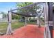 Covered patio with a brick floor and privacy curtains at 710 Carlton Ave, Lake Wales, FL 33853