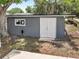 Backyard shed featuring a side window and double doors at 710 Carlton Ave, Lake Wales, FL 33853