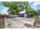 Backyard shed featuring a concrete driveway and a large tree at 710 Carlton Ave, Lake Wales, FL 33853
