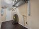 Utility room featuring laminate flooring, water heater, and access to the exterior at 710 Carlton Ave, Lake Wales, FL 33853