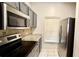 Close-up on stainless steel appliances in the kitchen with granite countertops at 8517 Bay Lilly Loop, Kissimmee, FL 34747