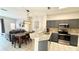 Open-concept kitchen boasts granite counters, stainless appliances, and breakfast bar at 8517 Bay Lilly Loop, Kissimmee, FL 34747