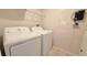 Laundry room featuring a white washer and dryer, and a wire shelf for storage at 8517 Bay Lilly Loop, Kissimmee, FL 34747