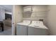 Convenient laundry room with washer, dryer, and overhead shelving at 8517 Bay Lilly Loop, Kissimmee, FL 34747