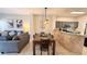 Open-concept living area featuring a dining table, view of kitchen and comfortable seating at 8517 Bay Lilly Loop, Kissimmee, FL 34747