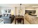 A combined living room and dining room area, with stainless steel appliances in kitchen at 8517 Bay Lilly Loop, Kissimmee, FL 34747