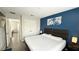 Tastefully decorated main bedroom with ensuite and a blue accent wall at 8517 Bay Lilly Loop, Kissimmee, FL 34747