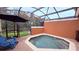 Enclosed pool area with lounge seating for relaxing and enjoying the outdoors at 8517 Bay Lilly Loop, Kissimmee, FL 34747