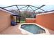 Relaxing outdoor pool area with covered enclosure, providing ample seating and a tranquil setting at 8517 Bay Lilly Loop, Kissimmee, FL 34747