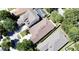An aerial view of multiple houses with brown roofs surrounded by beautiful green trees at 8835 Abbey Leaf Ln, Orlando, FL 32827