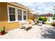 Backyard patio featuring outdoor seating, a white umbrella, and lush landscaping at 8835 Abbey Leaf Ln, Orlando, FL 32827