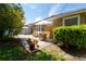 Backyard with patio, comfortable seating area, lush landscaping and sunny skies at 8835 Abbey Leaf Ln, Orlando, FL 32827