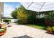 Beautiful backyard with a brick-paved patio, outdoor seating, and lush greenery at 8835 Abbey Leaf Ln, Orlando, FL 32827