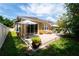 Spacious backyard featuring a patio, outdoor seating, lush landscaping, and sunny skies at 8835 Abbey Leaf Ln, Orlando, FL 32827