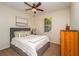 Inviting bedroom with a comfortable bed, natural light, and wood furniture at 8835 Abbey Leaf Ln, Orlando, FL 32827