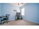 Bright bedroom featuring light blue walls, beige carpet, and a ceiling fan at 8835 Abbey Leaf Ln, Orlando, FL 32827